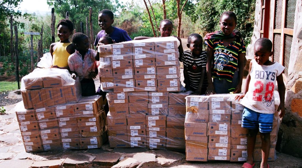 Children with the donated shoes
