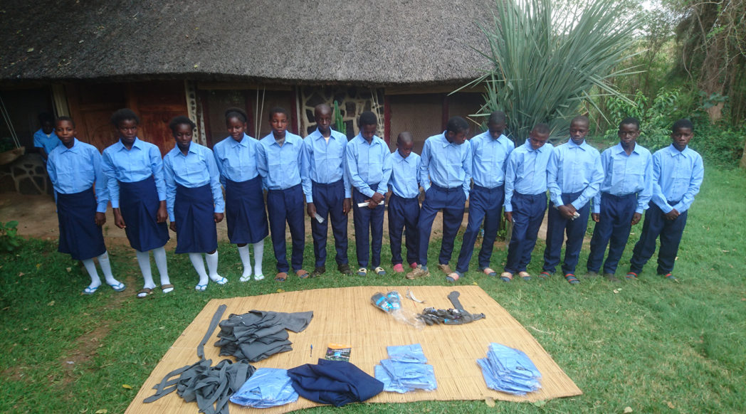 School students getting fitted with donated uniforms
